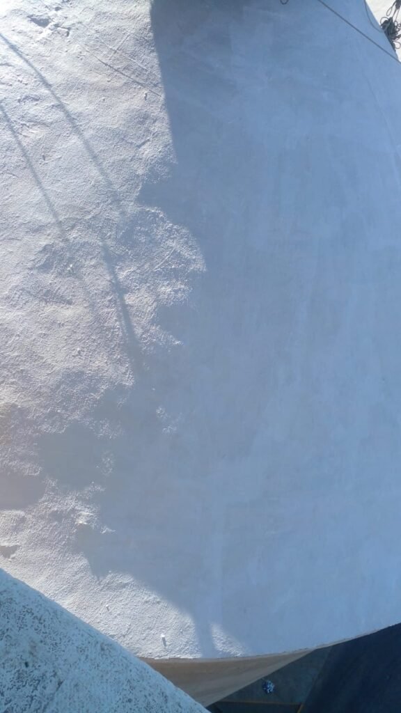 Extreme close-up of a silo roof showing detailed painting and waterproofing work by APR Waterproofing.