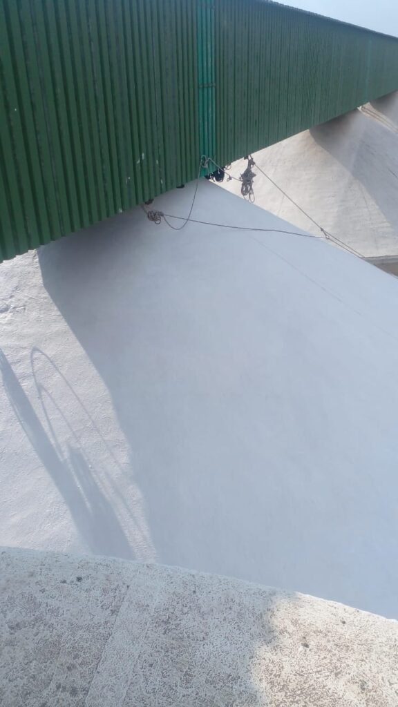 Close-up view of a silo roof during the painting and waterproofing process by APR Waterproofing.