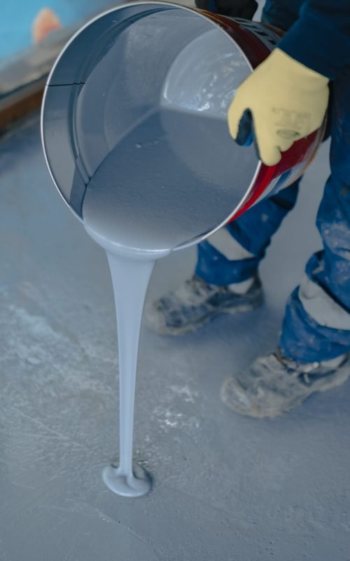 APR Waterproofing applying resin coating on a floor for a sleek and durable finish.